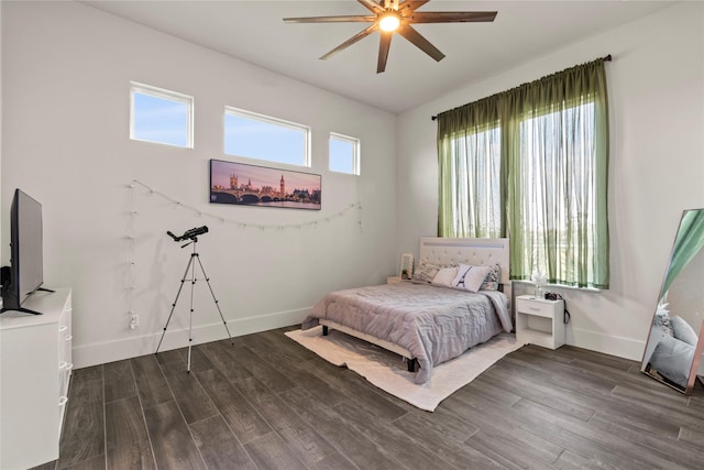 bedroom with baseboards, ceiling fan, and wood finished floors