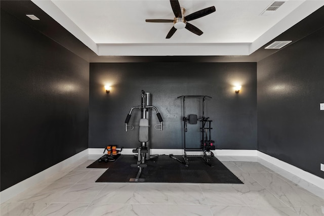 exercise room with baseboards, ceiling fan, marble finish floor, and visible vents