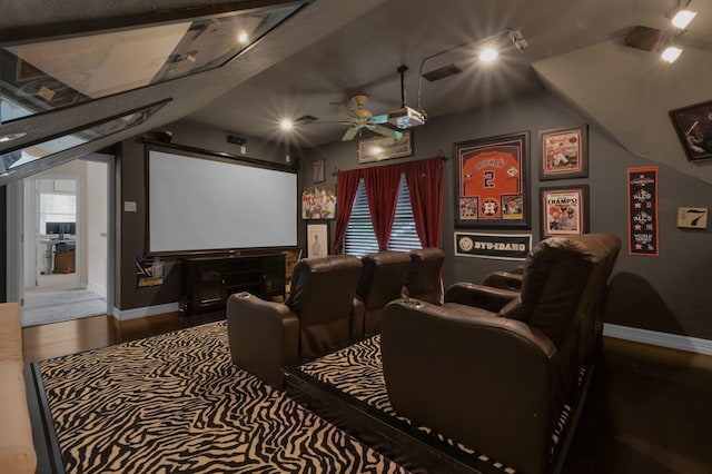 home theater featuring baseboards, a ceiling fan, wood finished floors, and visible vents