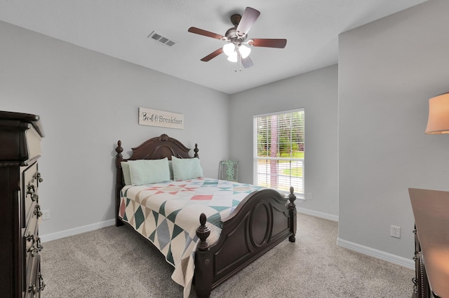bedroom featuring baseboards, ceiling fan, light colored carpet, and visible vents