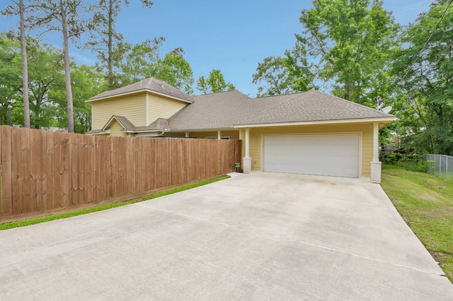 view of front of house with fence, an attached garage, a shingled roof, central AC unit, and driveway