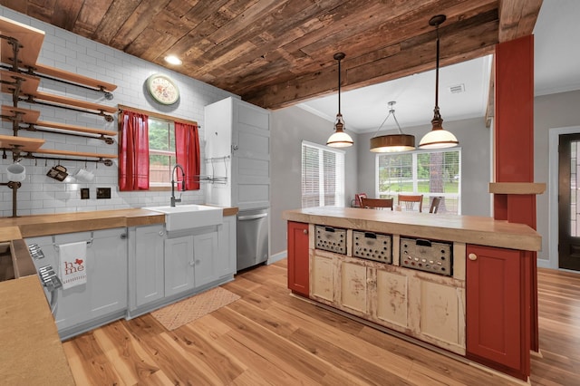 kitchen with crown molding, open shelves, stainless steel dishwasher, wood counters, and light wood finished floors