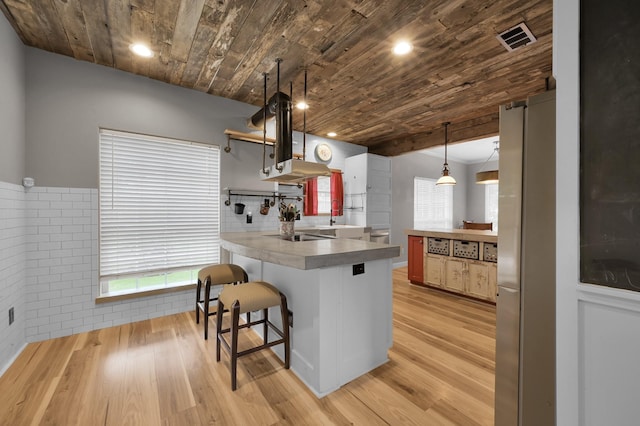 kitchen with wood ceiling, visible vents, open shelves, freestanding refrigerator, and a peninsula