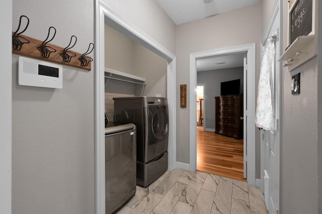 laundry room featuring laundry area, marble finish floor, and washer and clothes dryer