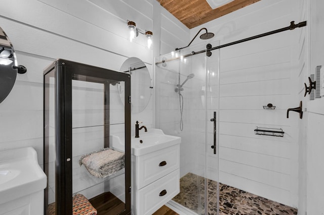 bathroom featuring vanity, wood ceiling, and a stall shower