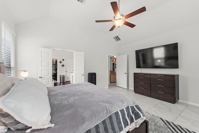 bedroom with a walk in closet, baseboards, vaulted ceiling, and visible vents