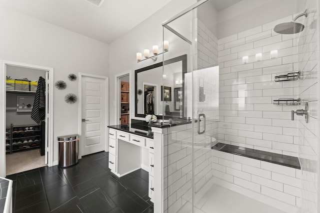 bathroom featuring a spacious closet, tile patterned flooring, and a stall shower