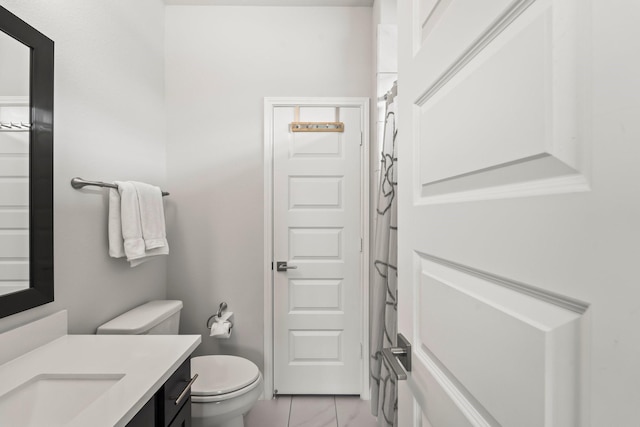 full bath featuring vanity, tile patterned floors, and toilet