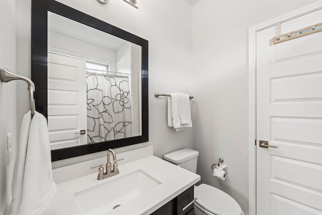 bathroom featuring vanity, a shower with curtain, and toilet