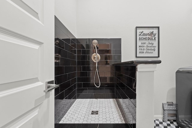 bathroom with tile patterned flooring and tiled shower