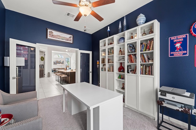 office with visible vents, a ceiling fan, and light colored carpet