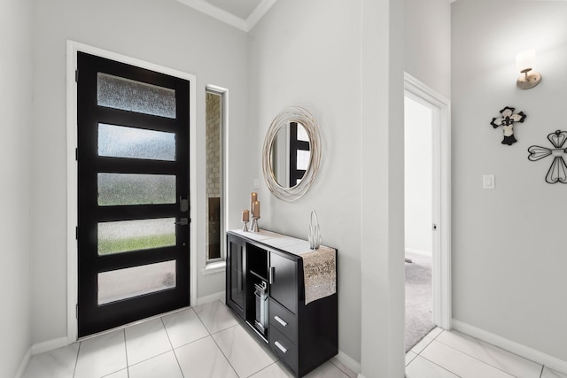 foyer with crown molding and baseboards