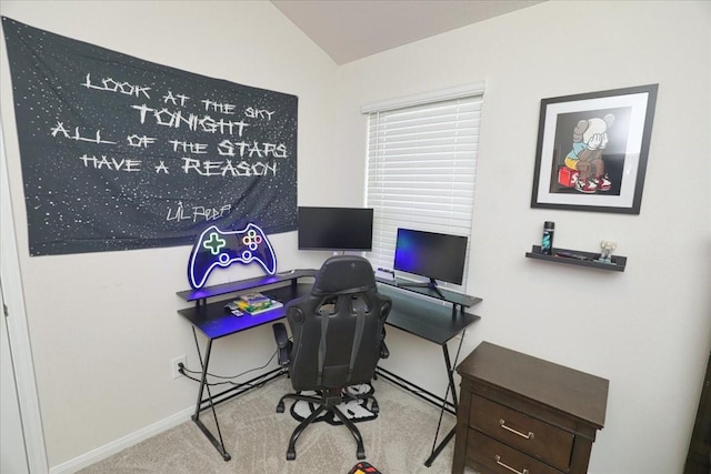 carpeted office space with baseboards and lofted ceiling