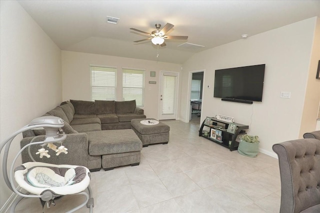 living room with visible vents, baseboards, a ceiling fan, light tile patterned floors, and vaulted ceiling