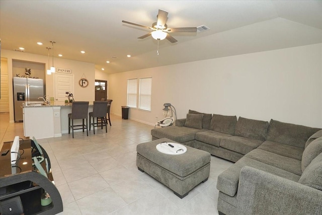 living area featuring ceiling fan, vaulted ceiling, light tile patterned floors, baseboards, and recessed lighting