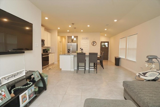 living area with recessed lighting, baseboards, vaulted ceiling, and light tile patterned floors
