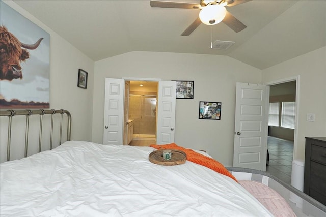 bedroom featuring ceiling fan, ensuite bathroom, and lofted ceiling