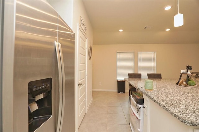 kitchen featuring light stone countertops, recessed lighting, white cabinetry, light tile patterned floors, and stainless steel refrigerator with ice dispenser
