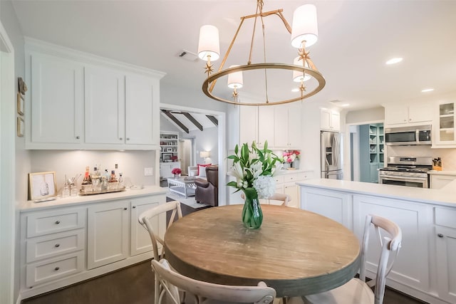 dining space featuring an inviting chandelier, dark wood-type flooring, recessed lighting, and visible vents