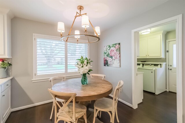 dining area featuring baseboards, washing machine and clothes dryer, a notable chandelier, and dark wood-type flooring