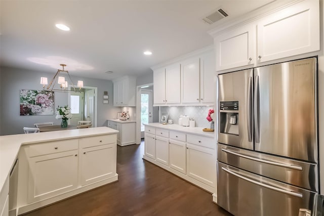 kitchen featuring white cabinets, appliances with stainless steel finishes, light countertops, visible vents, and dark wood-style floors