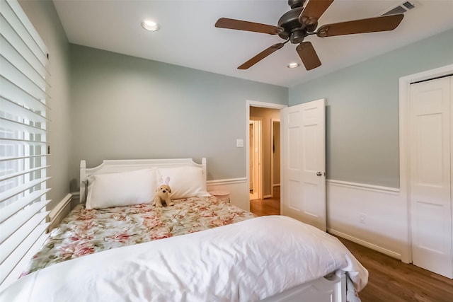 bedroom featuring ceiling fan, visible vents, wood finished floors, baseboards, and recessed lighting