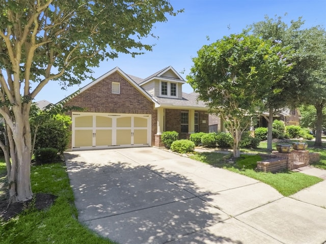 view of front facade featuring an attached garage, brick siding, and driveway