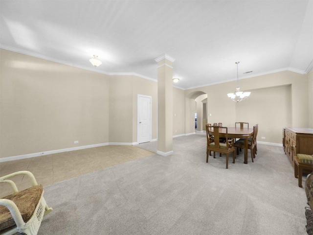 dining room featuring ornamental molding, baseboards, arched walkways, and an inviting chandelier