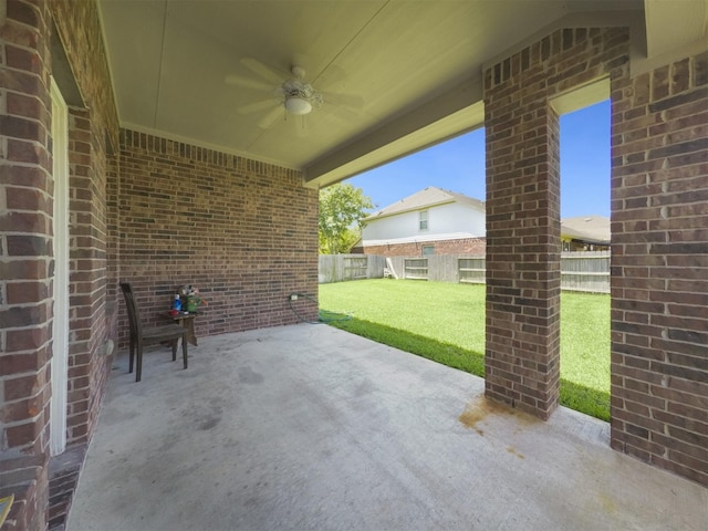 view of patio with a fenced backyard and a ceiling fan
