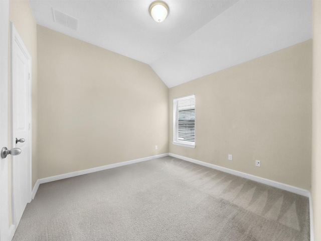 unfurnished room with baseboards, lofted ceiling, visible vents, and carpet