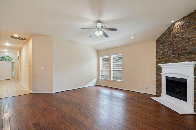 unfurnished living room with ceiling fan, visible vents, a fireplace, wood-type flooring, and lofted ceiling