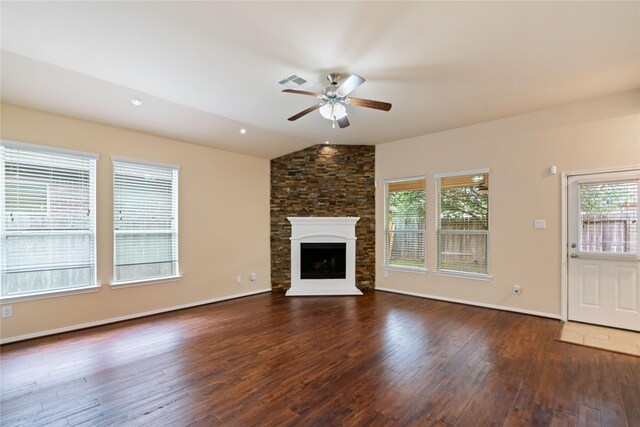 unfurnished living room featuring ceiling fan, visible vents, vaulted ceiling, wood finished floors, and a wealth of natural light