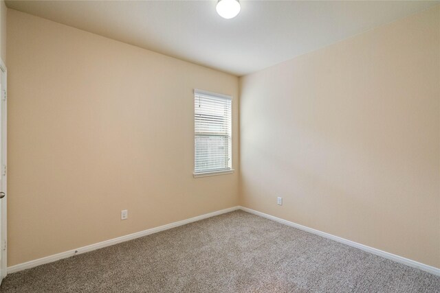carpeted spare room with baseboards
