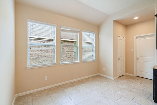 unfurnished room with baseboards