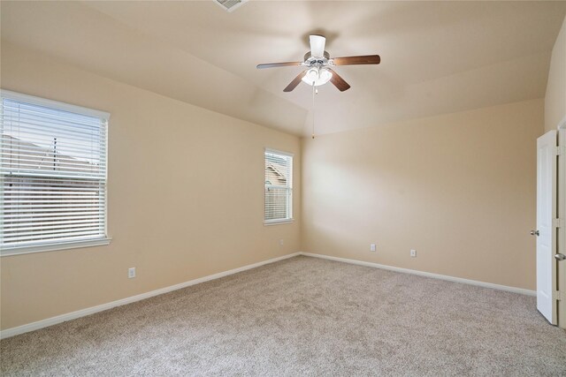 unfurnished room featuring baseboards, ceiling fan, carpet, and lofted ceiling