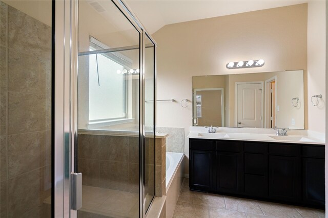 full bathroom featuring a sink, a stall shower, a bath, and lofted ceiling