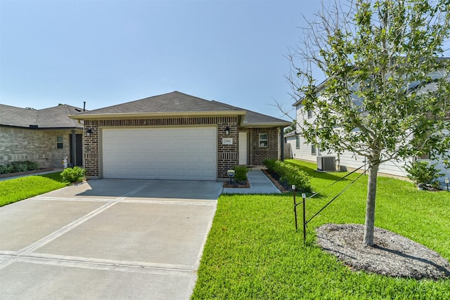 single story home with brick siding, central AC unit, an attached garage, and concrete driveway