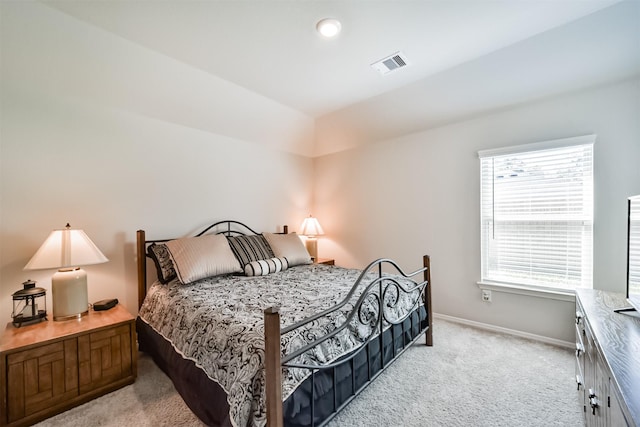 carpeted bedroom with baseboards, lofted ceiling, and visible vents