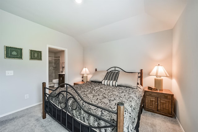 carpeted bedroom featuring baseboards, connected bathroom, and lofted ceiling