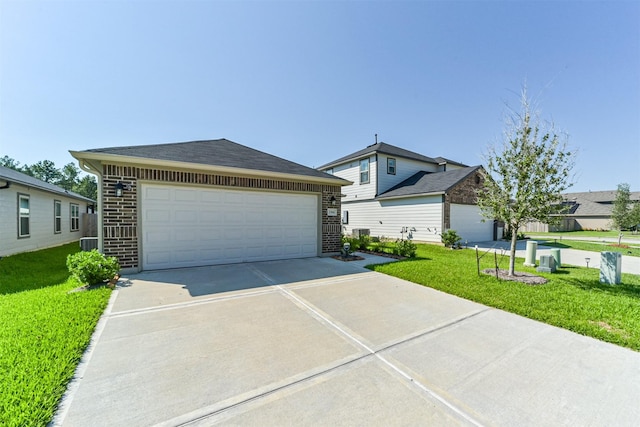 ranch-style home featuring roof with shingles, an outdoor structure, brick siding, and a front yard