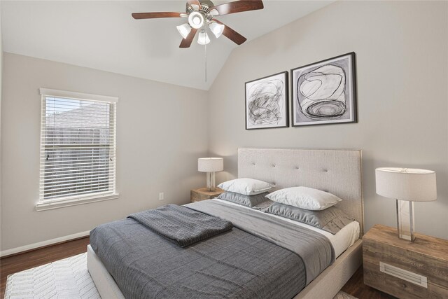 bedroom featuring baseboards, a ceiling fan, vaulted ceiling, and wood finished floors