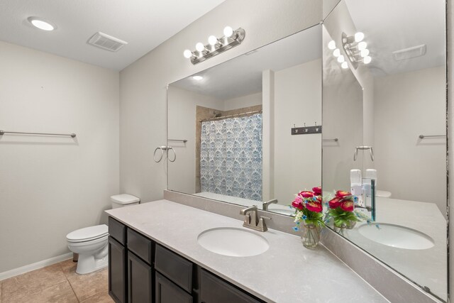 bathroom with vanity, toilet, tile patterned floors, a shower with shower curtain, and visible vents