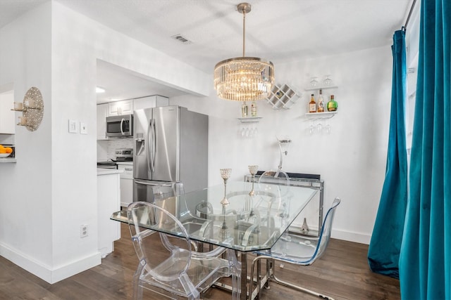 9502 Windswept Ln Unit 9502, Houston, TX 77063 - dining area featuring baseboards, dark wood finished floors, a chandelier, and visible vents