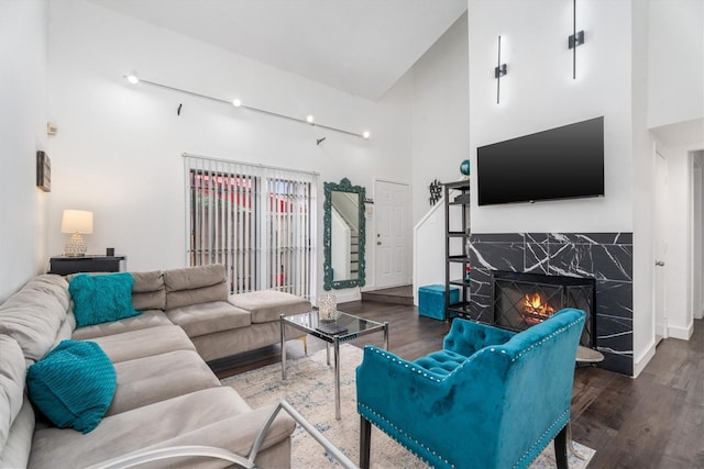 9502 Windswept Ln Unit 9502, Houston, TX 77063 - living room with a premium fireplace, wood finished floors, and a towering ceiling