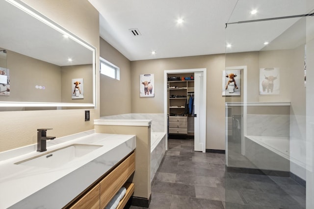 7711 Oxfordshire Dr, Spring, TX 77379 - full bath featuring recessed lighting, visible vents, a spacious closet, and a garden tub