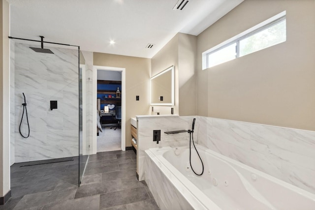 7711 Oxfordshire Dr, Spring, TX 77379 - bathroom with visible vents, vanity, a jetted tub, baseboards, and a marble finish shower