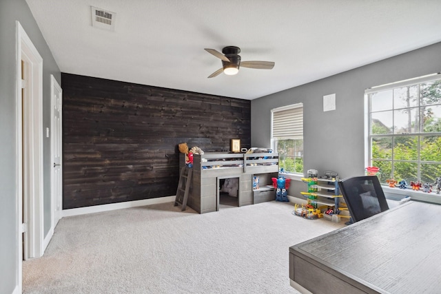 7711 Oxfordshire Dr, Spring, TX 77379 - carpeted home office featuring baseboards, a wealth of natural light, a ceiling fan, and visible vents