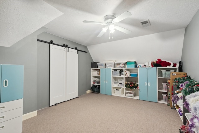 7711 Oxfordshire Dr, Spring, TX 77379 - playroom featuring a ceiling fan, a textured ceiling, visible vents, and a barn door