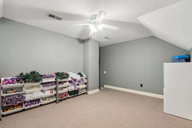 7711 Oxfordshire Dr, Spring, TX 77379 - playroom with visible vents, carpet floors, lofted ceiling, ceiling fan, and a textured ceiling