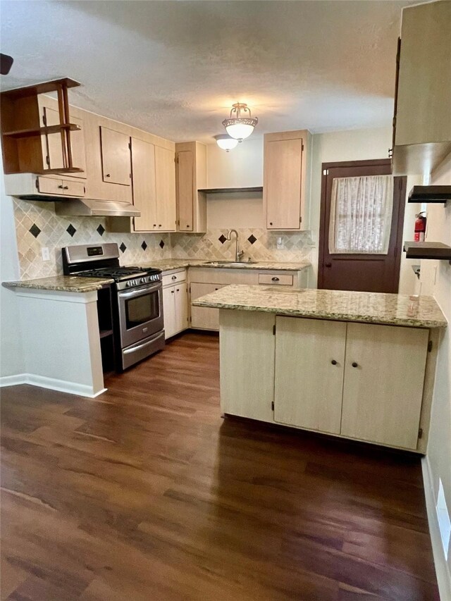 kitchen with open shelves, a sink, stainless steel range with gas stovetop, decorative backsplash, and dark wood-style floors